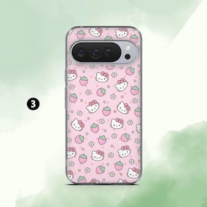 May include: A pink phone case featuring a repeating pattern of Hello Kitty faces, strawberries, and small white flowers. The case has a clear border and a camera cutout. The number "3" is in a black circle in the upper left corner.