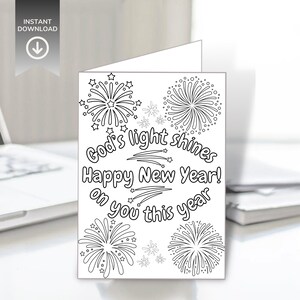 Op de afbeelding: Een witte wenskaart met zwarte lijntekeningen van vuurwerk en de tekst "God's light shines Happy New Year! on you this year." De kaart heeft een "INSTANT DOWNLOAD" icoon.