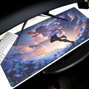 Op de afbeelding: Een rechthoekige gaming muismat met een fantasie-illustratie van een personage met een staf, rennend door een veld met blauwe bloemen. De achtergrond toont een zonsonderganghemel met wolken. Een wit toetsenbord en een zwarte polssteun zijn zichtbaar.