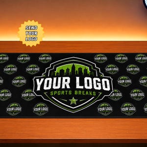 May include: A rectangular black desk mat featuring a repeating pattern of circular logos with a city skyline silhouette. In the center, a large shield-shaped emblem displays the text YOUR LOGO SPORTS BREAKS in white and green with a star.