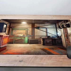 Pode incluir: Um tapete de rato retangular com uma cena interior detalhada e estilizada com uma bancada de trabalho, caixas e tubos. A paleta de cores inclui tons de castanho, laranja e azul. Um rato de computador preto é visível no lado direito.