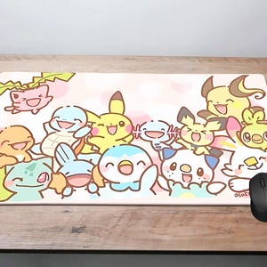 A mouse pad featuring a collection of colorful cartoon Pokemon characters, including Pikachu, Charizard, Bulmer, and others, arranged in a playful and vibrant manner.