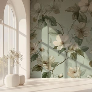 May include: A room with a floral wallpaper design featuring large white flowers and green leaves on a light green background. The room has a large arched window and white vases with dried plants. The floor is light-colored wood.