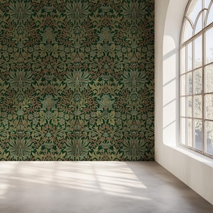 May include: A room featuring a wall adorned with dark green and gold floral wallpaper. The wallpaper showcases a repeating pattern of stylized leaves and flowers. A large arched window allows natural light, highlighting the room's concrete floor.