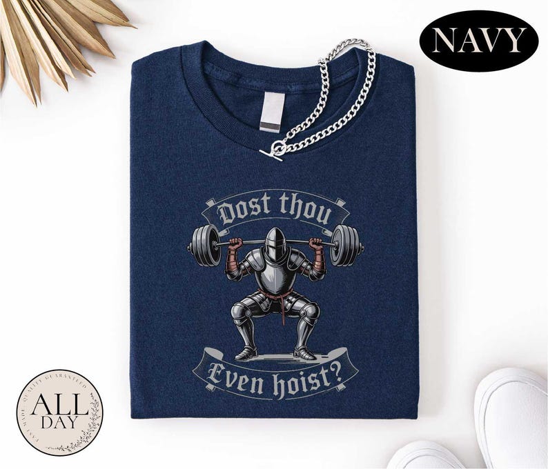 a navy blue t-shirt with a graphic design depicting a knight lifting a barbell, accompanied by the text "Do you think even hoist?"