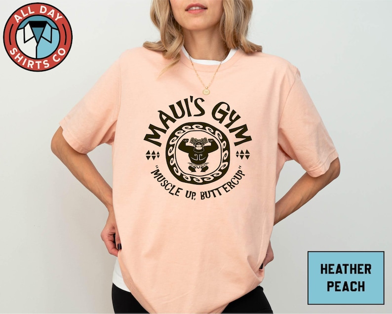 a woman wearing a pink shirt with the words mau's gun on it