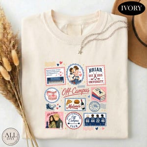 May include: An ivory t-shirt featuring a graphic print of various postage stamp-style illustrations. The designs include a couple, a piano, a stack of books, hockey skates, a pizza, a bottle, and four hockey jerseys with the numbers 66, 44, 22, and 46.