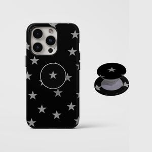 May include: Black phone case with silver glitter star pattern and a matching pop socket. The phone case has a black background with silver stars. The pop socket is black with a silver star design.