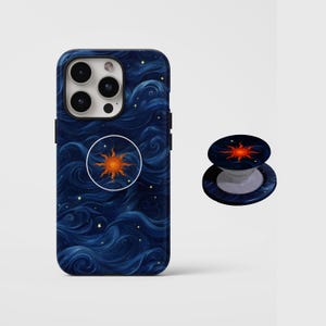 May include: A navy blue phone case and matching pop socket featuring a swirling blue and white design with a central orange sunburst. The case is designed to fit a smartphone, and the pop socket is a collapsible grip.