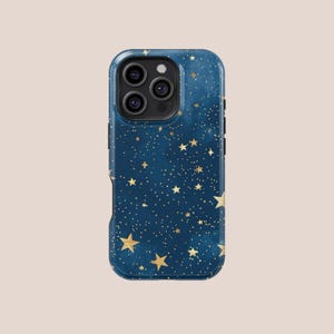 May include: A navy blue phone case with a celestial design. The case features a pattern of gold stars and tiny dots against a dark blue background. The phone case has a protective bumper and camera lens cutouts.