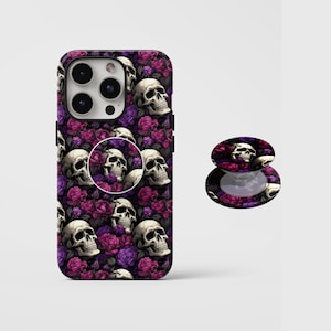 May include: A phone case and phone grip featuring a repeating pattern of skulls and roses in shades of purple, pink, and white. The phone case is on a white background.