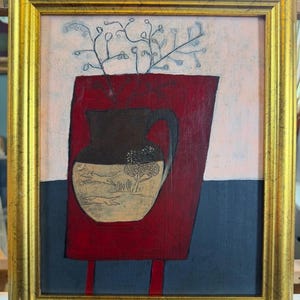 May include: A framed painting featuring a dark brown pitcher with a light-coloured base decorated with line drawings of animals and trees. The pitcher sits on a red rectangular surface against a pale pink and dark grey background with thin branches.