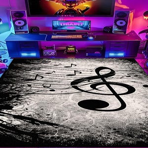 May include: A large rectangular area rug featuring a musical theme. The rug has a black and white color scheme with a large treble clef and musical notes. The design includes a distressed, grunge-style background.