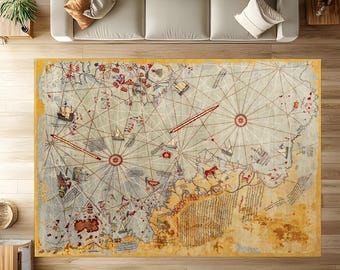 May include: A large rectangular area rug with a vintage map design. The rug features a cream-colored background with a detailed map in shades of blue, red, and brown. Ships, compass roses, and other nautical elements are visible. The rug is bordered with a yellow edge.