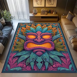 May include: A rectangular area rug featuring a stylized Tiki mask design. The rug showcases a vibrant color palette of purple, orange, blue, and green. The Tiki mask has large, orange eyes and a wide, toothy grin, surrounded by stylized leaves and floral patterns.