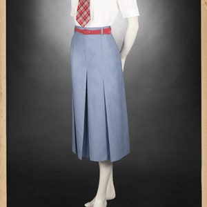 May include: A white collared shirt with short sleeves and a red and white plaid tie. The shirt is tucked into a light blue pleated skirt with a red belt.
