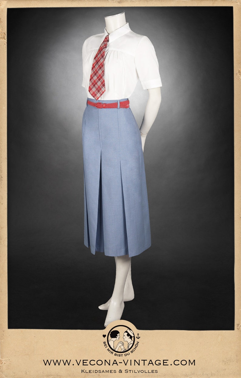 May include: A white collared shirt with short sleeves and a red and white plaid tie. The shirt is tucked into a light blue pleated skirt with a red belt.