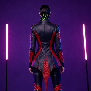 May include: Black and red leather jacket with diamond-patterned accents. The jacket features a pointed tail and red trim along the back and sleeves. The model is wearing black leather pants. The background is a gradient of purple.