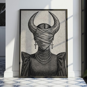 Könnte beinhalten: Gerahmter Schwarz-Weiß-Kunstdruck. Die Illustration zeigt eine Figur mit verhülltem Gesicht, großen Hörnern und Kreuzohrringen. Die Figur trägt eine mehrreihige Halskette und ein dunkles Kleid. Das Kunstwerk wird in einem Raum mit gemustertem Boden ausgestellt.