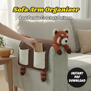 May include: A brown crochet sofa arm organizer with two white pockets and a red panda design. The organizer is placed on the arm of a gray sofa. The text "Sofa Arm Organizer" and "Red Panda Crochet Pattern" are displayed at the top.