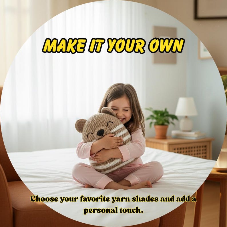 May include: A crocheted bear-shaped pillow in shades of tan and white is held by a person. The pillow has a smiling face and striped design. Text above reads "MAKE IT YOUR OWN". Text below reads "Choose your favorite yarn shades and add a personal touch."