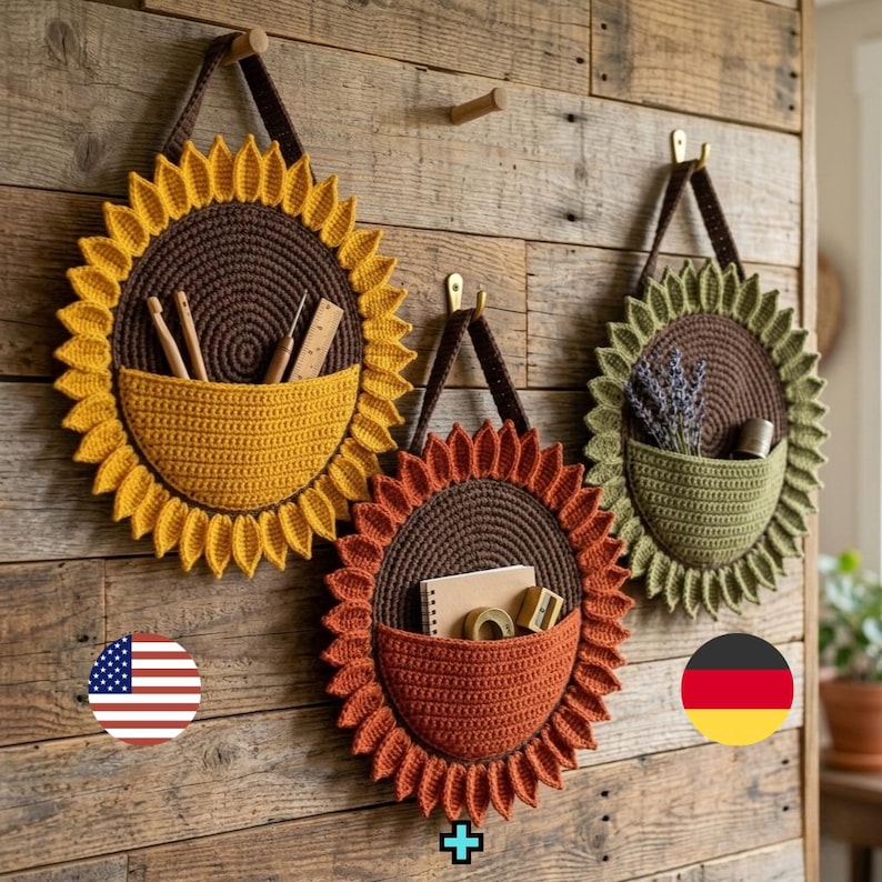 May include: Three circular crochet wall organizers shaped like flowers. The left one is yellow, the center is orange, and the right is green. Each has a dark brown center, a hanging strap, and a front pocket containing various small items.