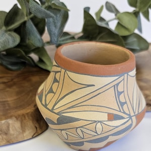 May include: A set of three ceramic mugs with a speckled, matte finish. The mugs are in shades of cream, light gray, and dark gray. Each mug has a simple, minimalist design, perfect for coffee or tea.
