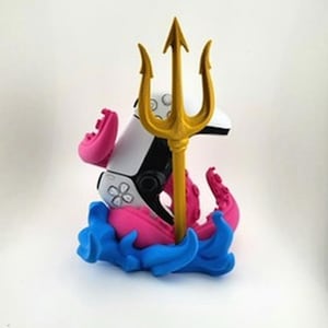 May include: A whimsical sculpture featuring a white and black controller with a gold trident. Pink tentacles and blue waves form the base. The controller has a flower design on it.