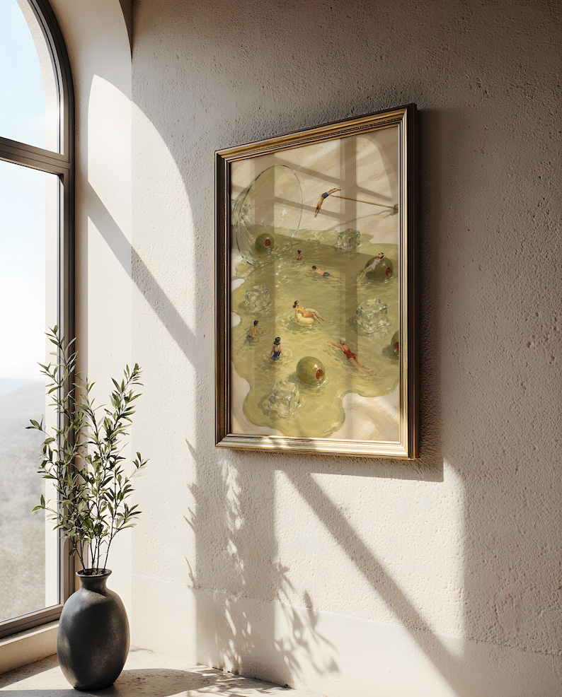 May include: A framed wall art print depicting a martini glass tipped over, spilling a pale yellow liquid that forms a pool. Within the liquid, several small figures are swimming among large green olives and translucent ice cubes.
