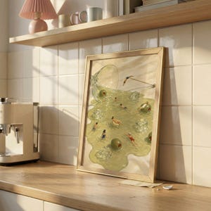May include: A framed rectangular art print featuring a spilled martini glass with green olives and ice cubes acting as a swimming pool for tiny figures. The illustration depicts people swimming and lounging in the spilled liquid on a light surface.