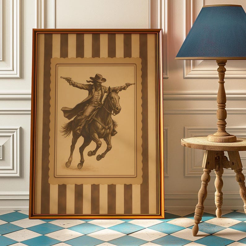 May include: Framed vintage-style artwork depicting a cowboy on horseback, firing two pistols. The artwork is in sepia tones, framed in a gold-colored frame, and set against a striped background. The artwork is displayed on a blue and white checkered floor.