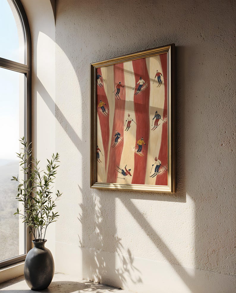 May include: A framed rectangular wall art print featuring a vertical pattern of alternating cream and deep red stripes. The artwork depicts multiple small figures skiing down the slopes in various colorful winter outfits and gear.