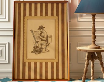May include: Framed artwork featuring a sepia-toned illustration of a person in a cowboy hat reading a newspaper while seated on a toilet. The artwork is set against a brown and cream striped background.