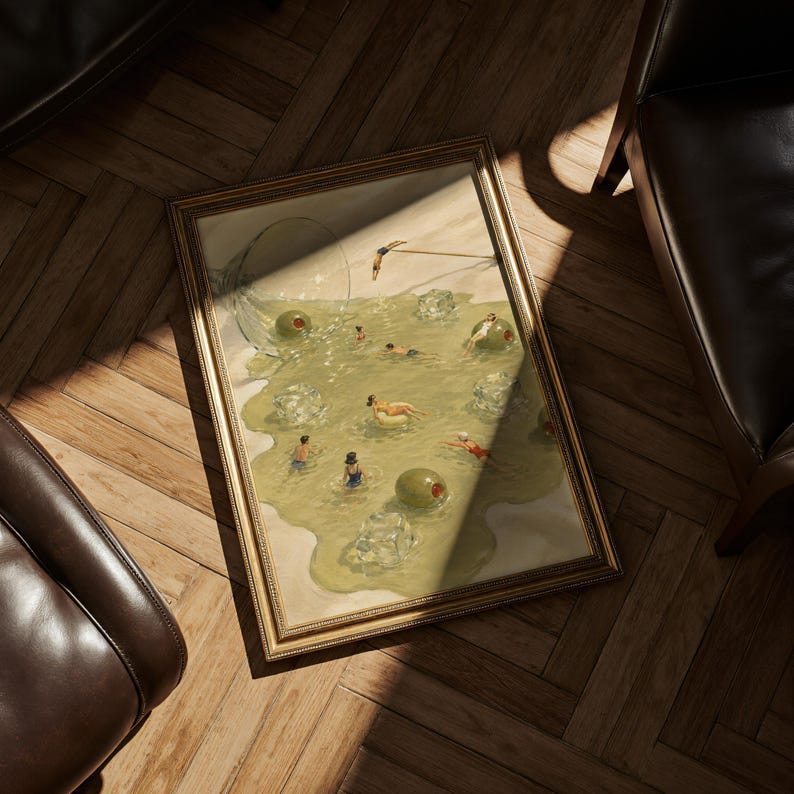 May include: A framed rectangular print featuring a surreal illustration of people swimming in a spilled martini. The scene includes large green olives, clear ice cubes, and a tipped glass, all rendered in shades of olive green and pale yellow.