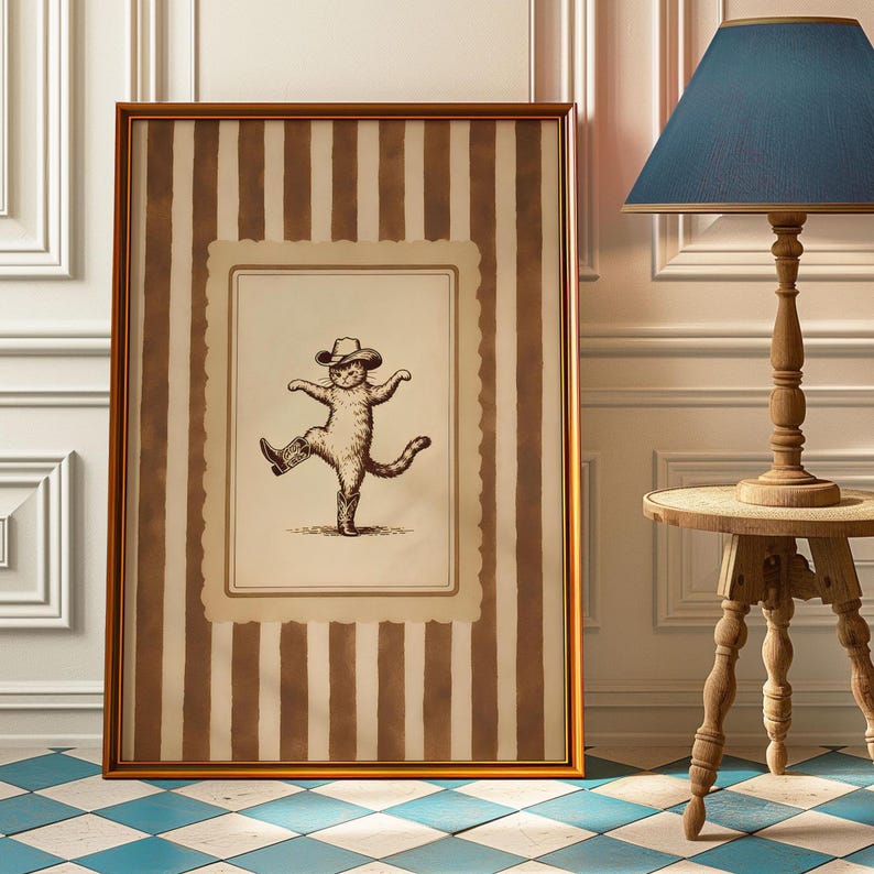 May include: Framed artwork featuring a dancing cat wearing a cowboy hat and boots. The artwork is in a gold frame with a striped background in shades of brown and cream. The floor is a blue and white checkered pattern.