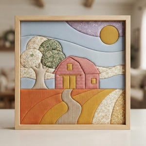 May include: A framed fabric wall art piece featuring a quilted landscape scene. The image depicts a red checkered barn, a tree with floral patterned foliage, a yellow sun, and a winding path through orange, yellow, and cream fabric fields.