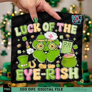 May include: Black graphic featuring a green clover with glasses, a nurse's hat, and a pot of gold. Text reads "Luck of the Eye-rish" in colorful letters. Includes a leprechaun hat and horseshoe.
