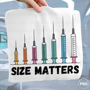 May include: A white fabric item featuring a graphic of seven syringes in increasing sizes, colored yellow, orange, pink, green, teal, blue, and white with pink, arranged in a row above the bold black text that reads SIZE MATTERS.