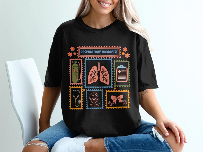 May include: Black t-shirt with a colorful graphic design featuring medical-themed postage stamps. The stamps include images of lungs, a stethoscope, and a medical chart. The text "RESPIRATORY THERAPIST" is displayed at the top.