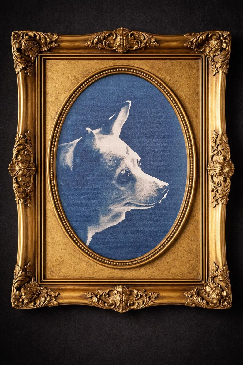 May include: A framed portrait of a dog in profile, set against a blue background. The dog is rendered in white, creating a striking contrast. The ornate, gold-colored frame adds a touch of elegance to the artwork.