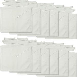 May include: A collection of white aprons with matching neck and waist ties. The aprons have a square shape with a large pocket and a diagonal seam. The ties are folded and ready to be attached.