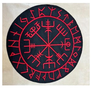 May include: A round black patch with red embroidered Viking symbols. The patch features a central compass-like design surrounded by runes. The symbols are intricately detailed, creating a striking contrast against the black background.
