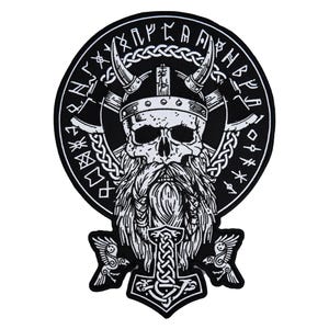 May include: Black and white patch featuring a Viking skull with a horned helmet, long beard, and axes. The design includes runes around the edge and a Thor's hammer at the bottom. A detailed, gothic-style emblem.