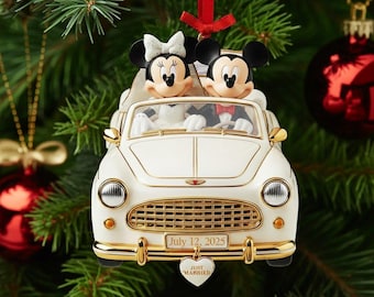 May include: A white convertible car Christmas ornament featuring Mickey and Minnie Mouse as a bride and groom. The license plate reads July 12, 2025, and a heart-shaped charm hanging from the front bumper is inscribed with the text JUST MARRIED.