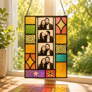 May include: A rectangular stained glass suncatcher featuring a central vertical column of four black and white photographs of a couple. The frame is composed of multi-colored textured glass panels in yellow, green, orange, red, and purple.