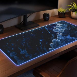 May include: A rectangular, black mouse pad with a blue and white cloud design and a glowing blue edge. The mouse pad is on a wooden desk with a computer monitor, speakers, and plants.