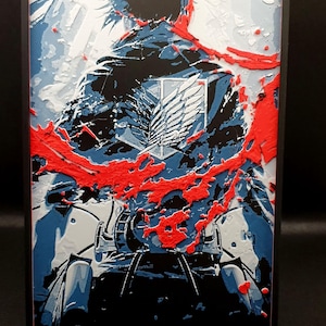 May include: Framed artwork depicting a character from "Attack on Titan." The image uses black, blue, white, and red, with a textured, painted look. The Survey Corps emblem is visible on the character's back, adding detail to the artwork.