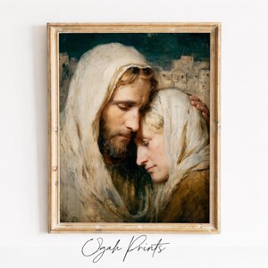 Könnte beinhalten: Ein gerahmter Druck mit einem religiösen Gemälde. Das Kunstwerk zeigt zwei Figuren in drapierten Gewändern, eine umarmt die andere. Die Farbpalette umfasst warme Töne von Beige, Braun und Gold mit einem dunkelgrünen Hintergrund. Der Text "Ogah Prints" befindet sich unten.