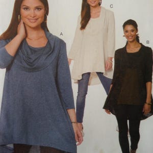 May include: A sewing pattern illustration featuring three tops. Style A is a blue cowl-neck tunic with three-quarter sleeves. Style C is a cream-colored tunic with a draped neckline. Style B is a black open-front cardigan worn over a dark top.