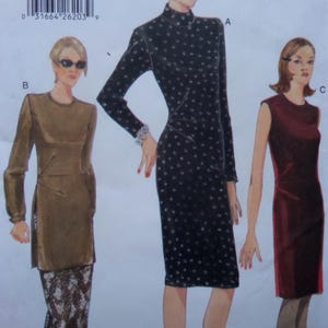 May include: A sewing pattern featuring three dress designs. One dress is black with white polka dots, another is a long-sleeved brown tunic, and the third is a sleeveless burgundy dress. The pattern includes a UPC code at the top.